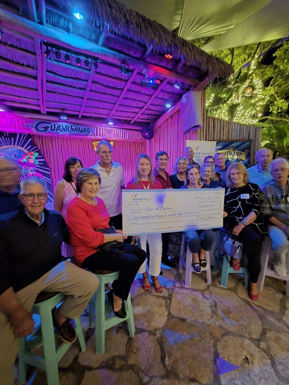 Club 100 receiving a check at the December 2025 event