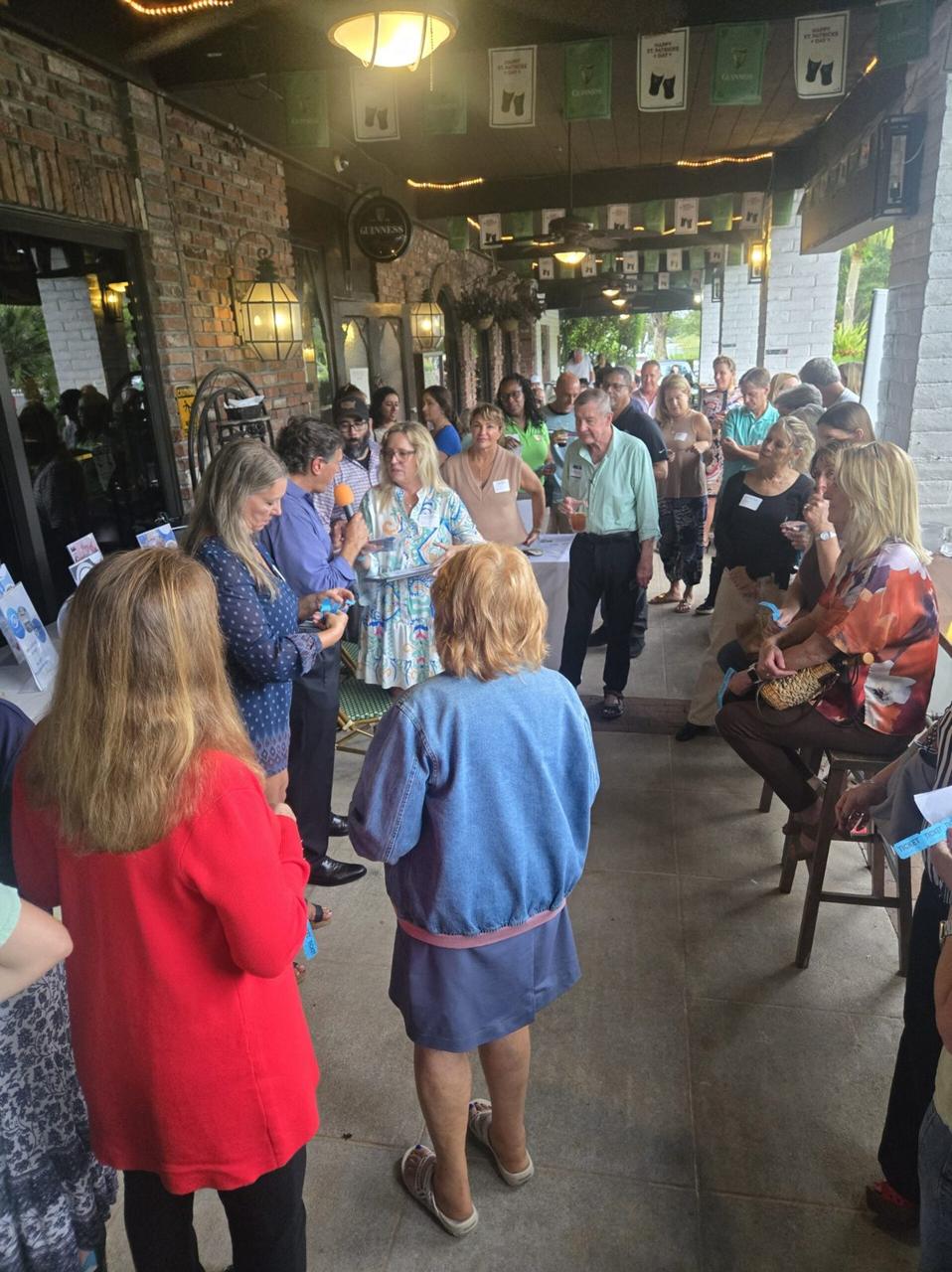 Guests networking on a restaurant patio at an NTHC event